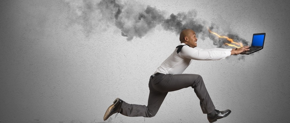 man running behind burning computer