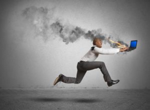 man running behind burning computer