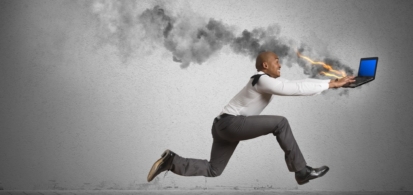 man running behind burning computer