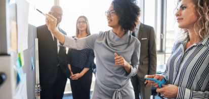 Diverse professionals, working together, centered on black female executive