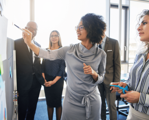 Diverse professionals, working together, centered on black female executive