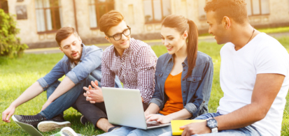 A diverse group of students demonstrating the results of simplifying SaaS adoption, gather outside a university building, looking at a laptop and each other