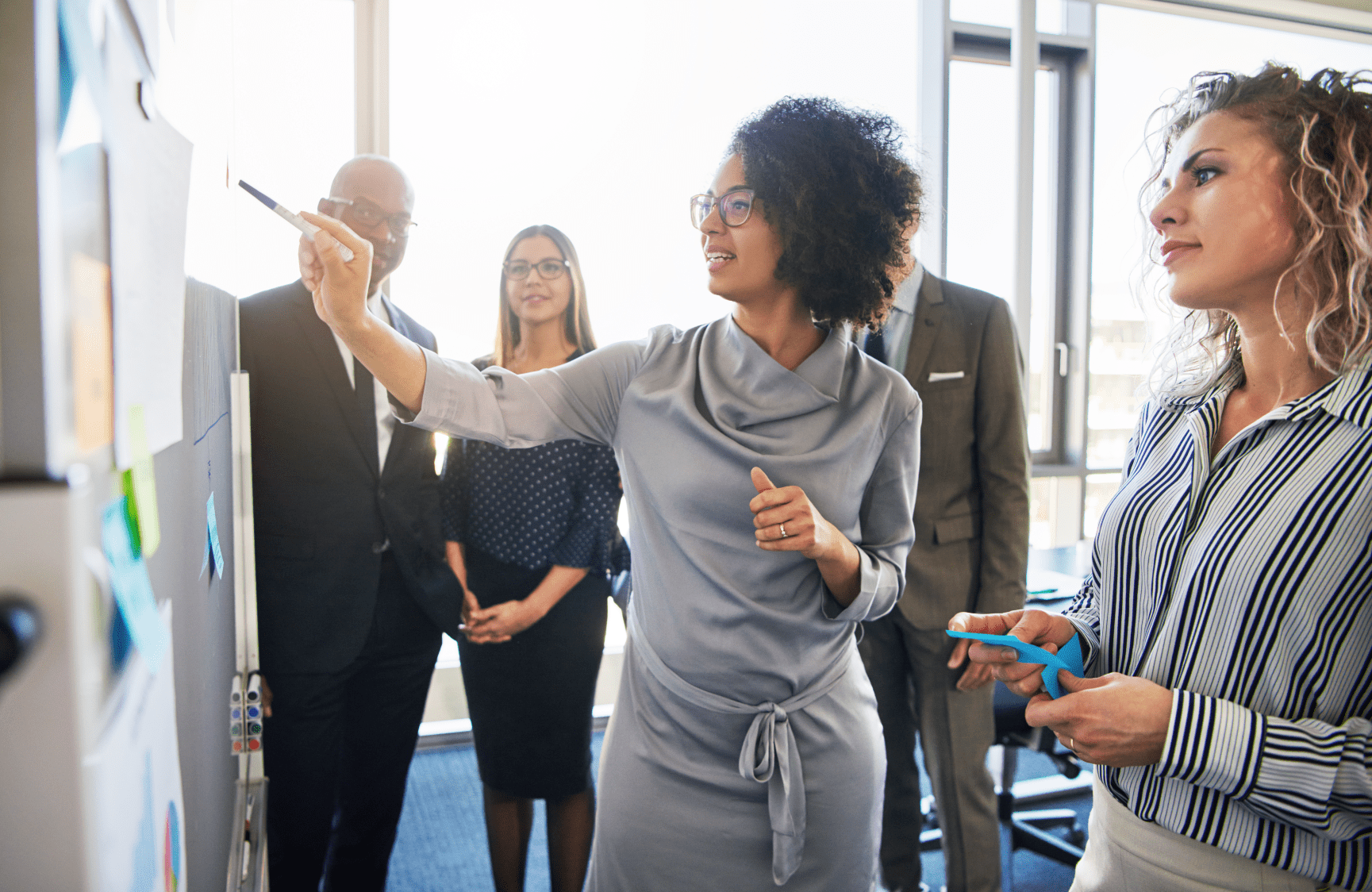 Diverse professionals, working together, centered on black female executive