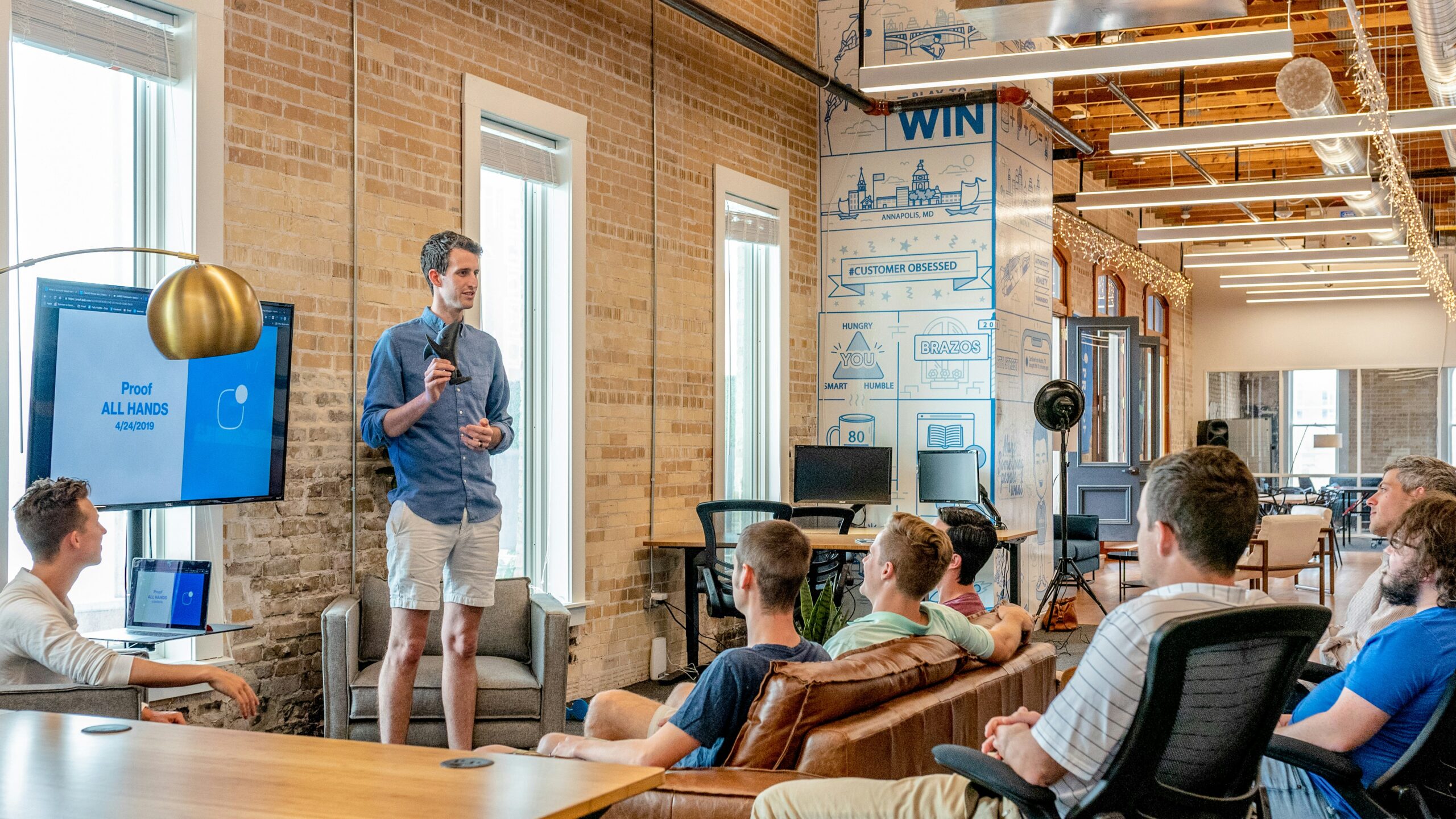 Entrepreneur presenting to team in modern workspace